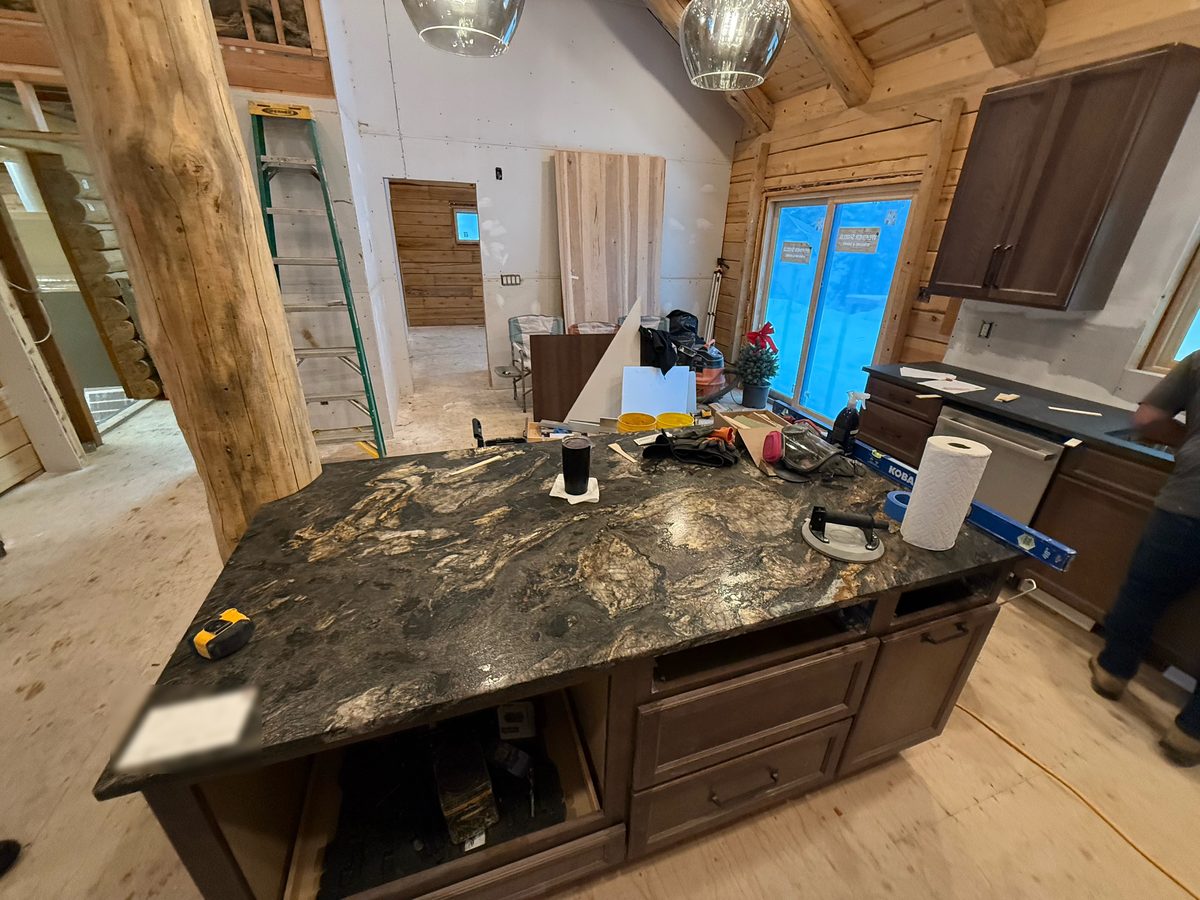 Granite kitchen island inside the log home during construction