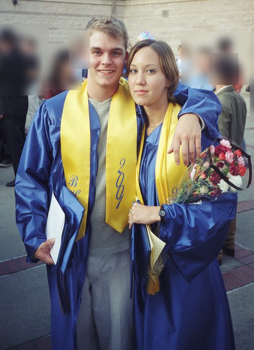 Michael and Raichelle in blue graduation gowns with 2001 stoles