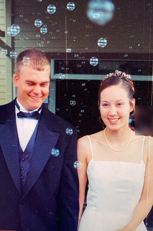 Michael and Raichelle smiling through bubbles on their wedding day